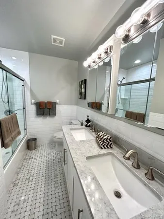 a bathroom with a sink double vanity and a mirror