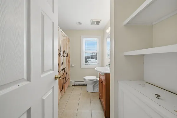 a bathroom with a toilet sink and shower