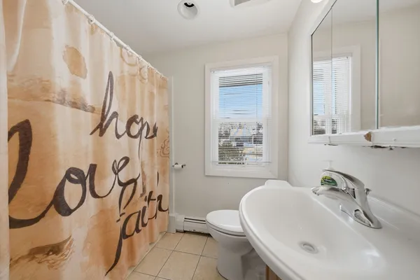 a bathroom with a sink and mirror with toilet