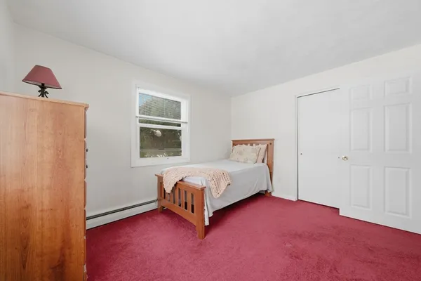 a spacious bedroom with a bed and a window