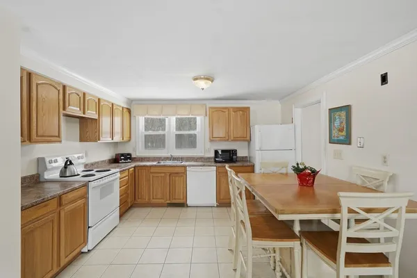 a kitchen with a stove a sink dishwasher and a refrigerator