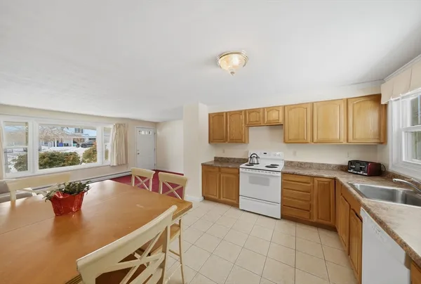 a kitchen with a stove a sink dishwasher and a refrigerator