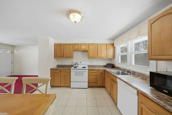 a kitchen with a stove top oven sink and cabinets