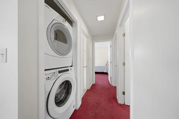 a view of a hallway with washer and dryer