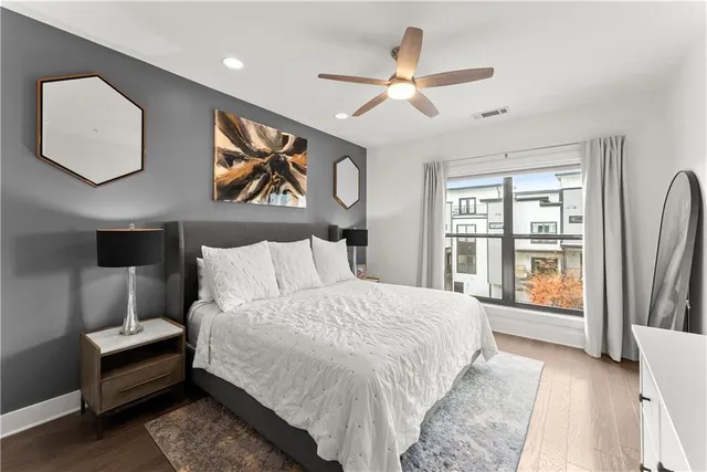 a bedroom with a large bed and a lamp