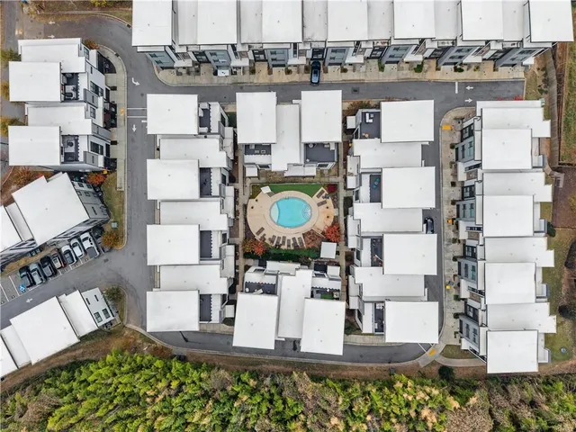an aerial view of a house with outdoor seating