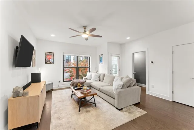 a living room with furniture and a flat screen tv