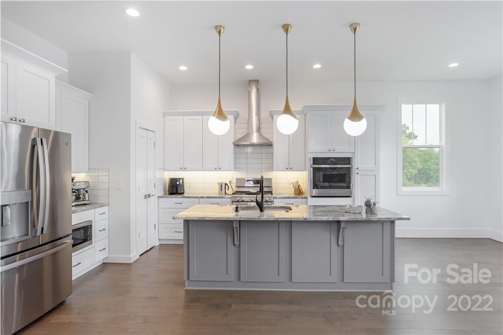 112 Meadow Breeze Road Arden, NC 28704 - Photo 11 of 44 a view of a kitchen with a sink and dishwasher a refrigerator with wooden floor