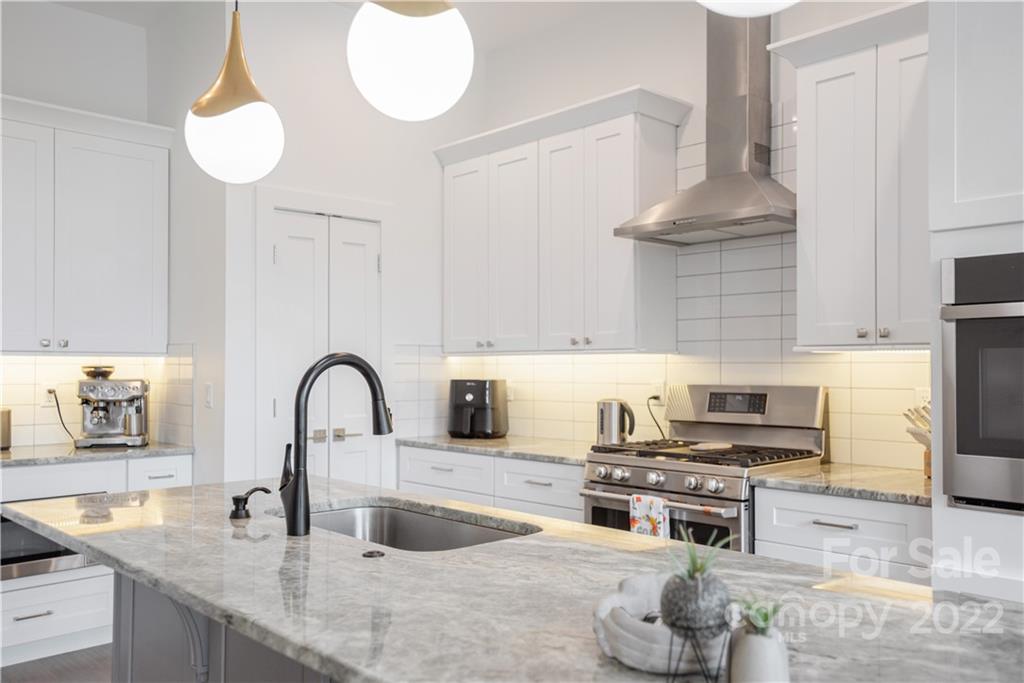 112 Meadow Breeze Road Arden, NC 28704 - Photo 13 of 44 a kitchen with stainless steel appliances granite countertop a sink and a stove