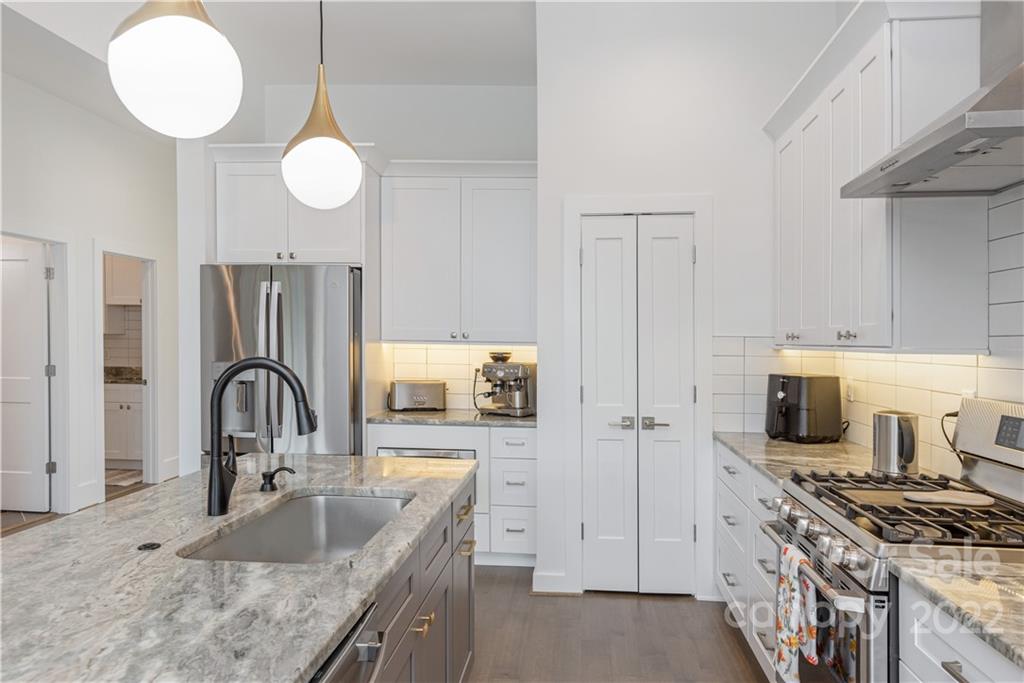 112 Meadow Breeze Road Arden, NC 28704 - Photo 14 of 44 a kitchen with stainless steel appliances granite countertop a sink stove and refrigerator