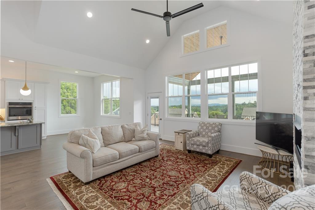 112 Meadow Breeze Road Arden, NC 28704 - Photo 18 of 44 a living room with furniture and a flat screen tv