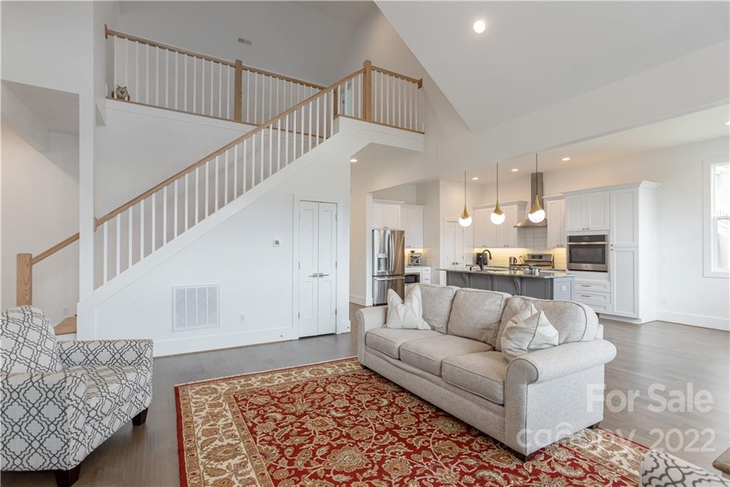 112 Meadow Breeze Road Arden, NC 28704 - Photo 19 of 44 a living room with furniture and stairs