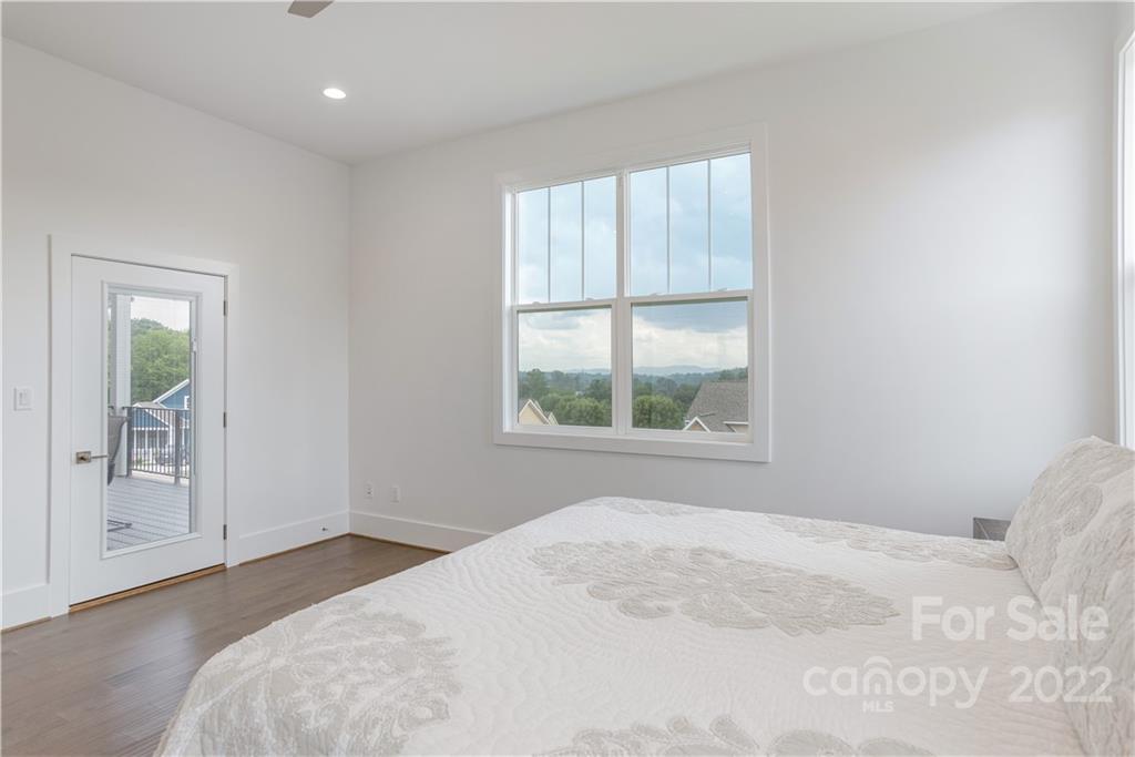 112 Meadow Breeze Road Arden, NC 28704 - Photo 21 of 44 a bedroom with a bed and a window