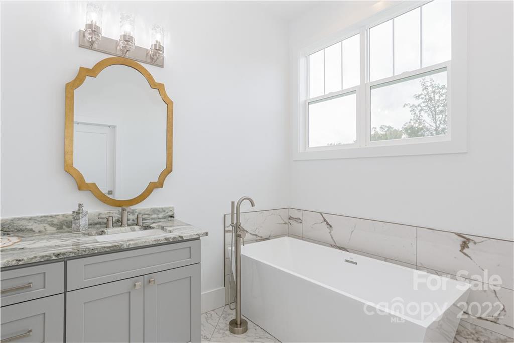112 Meadow Breeze Road Arden, NC 28704 - Photo 22 of 44 a bathroom with a granite countertop sink and a mirror