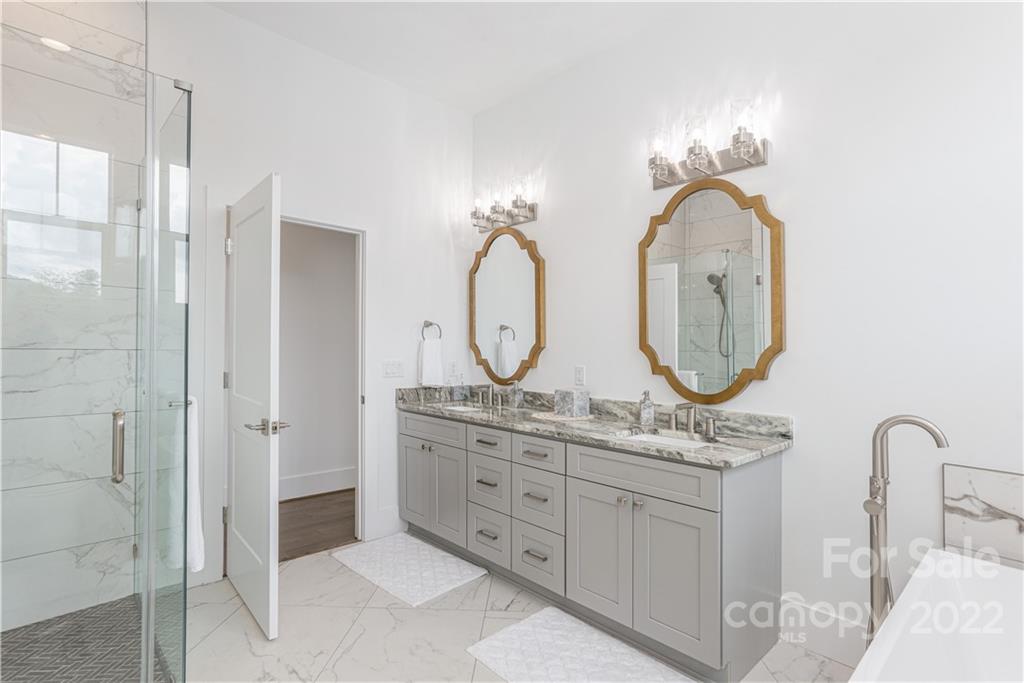 112 Meadow Breeze Road Arden, NC 28704 - Photo 23 of 44 a bathroom with a double vanity sink mirror and shower