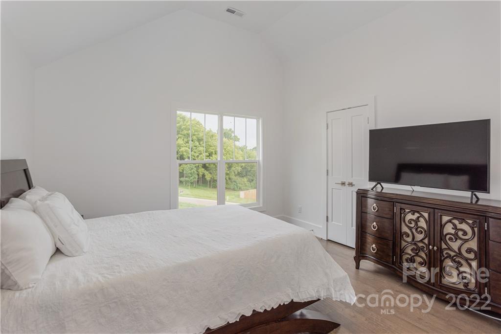 112 Meadow Breeze Road Arden, NC 28704 - Photo 29 of 44 a bedroom with a bed and a flat screen tv
