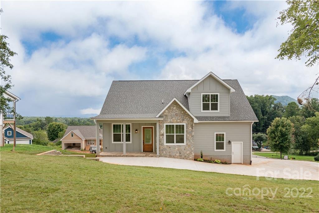 112 Meadow Breeze Road Arden, NC 28704 - Photo 6 of 44 a front view of a house with a garden and trees
