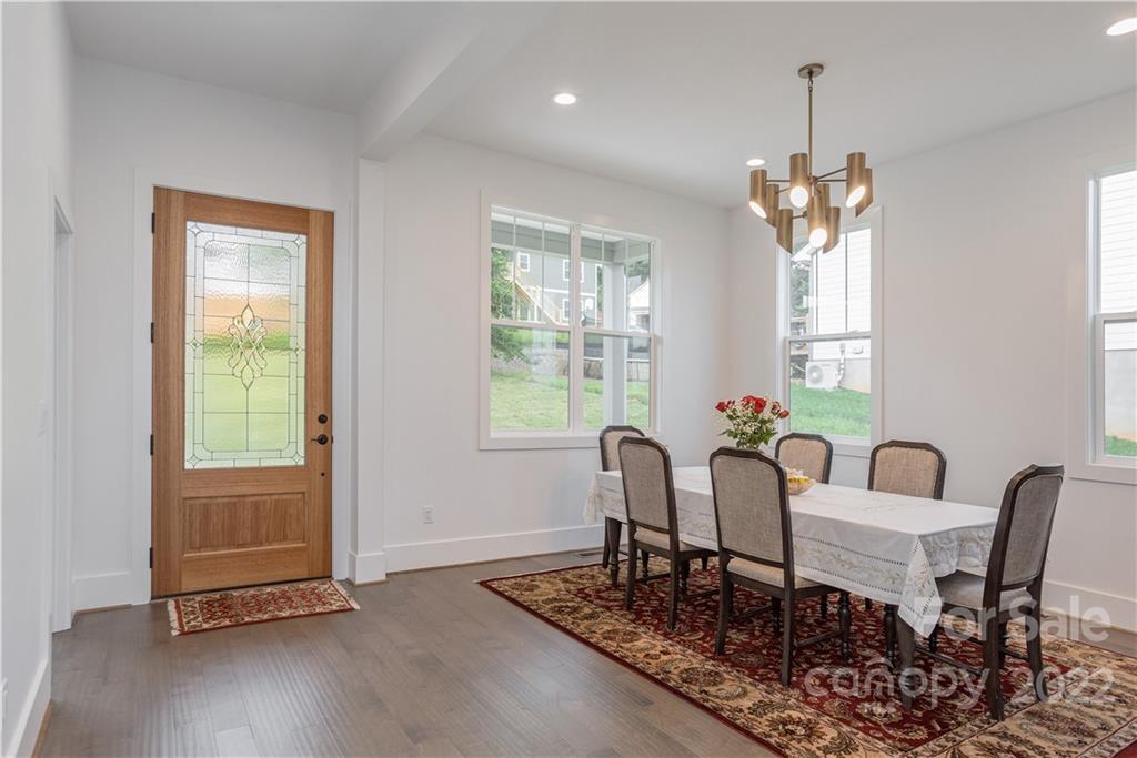 112 Meadow Breeze Road Arden, NC 28704 - Photo 7 of 44 a view of a dining room with furniture window and wooden floor