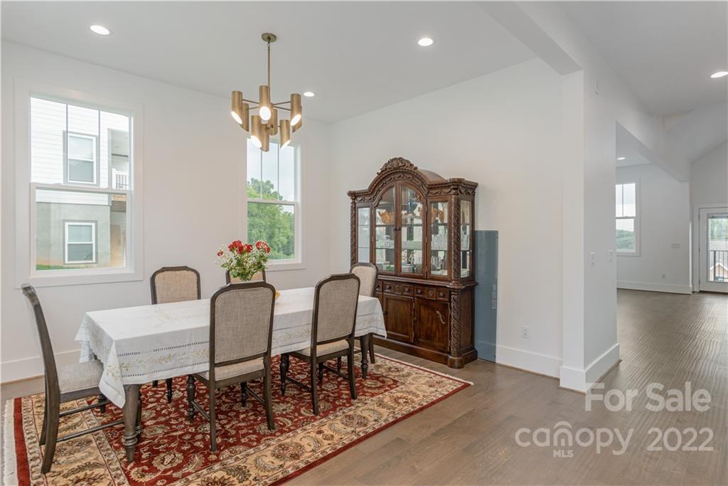 112 Meadow Breeze Road Arden, NC 28704 - Photo 8 of 44 a view of a dining room with furniture and a chandelier