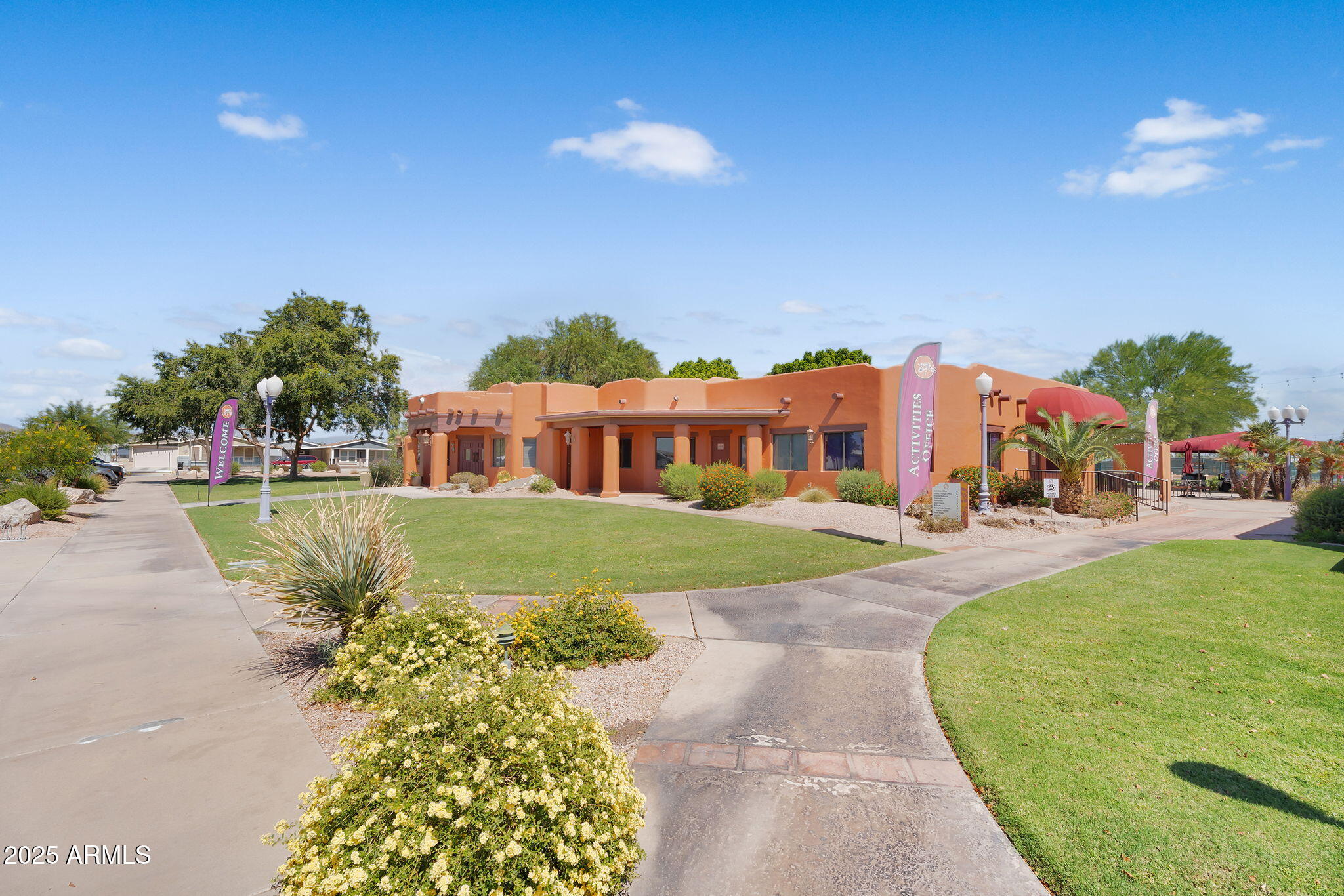 8865 East Baseline Road, Unit 802 Mesa, AZ 85209 - Photo 34 of 44 a view of a big house with a big yard and potted plants