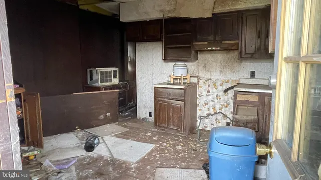 a patio with table and chairs and potted plants