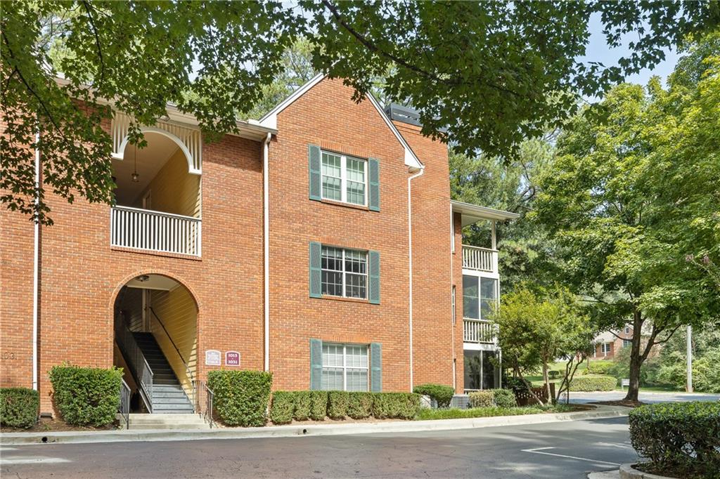 South face of gorgeous brick condo building on quiet corner lot with 2 assigned parking spaces.
