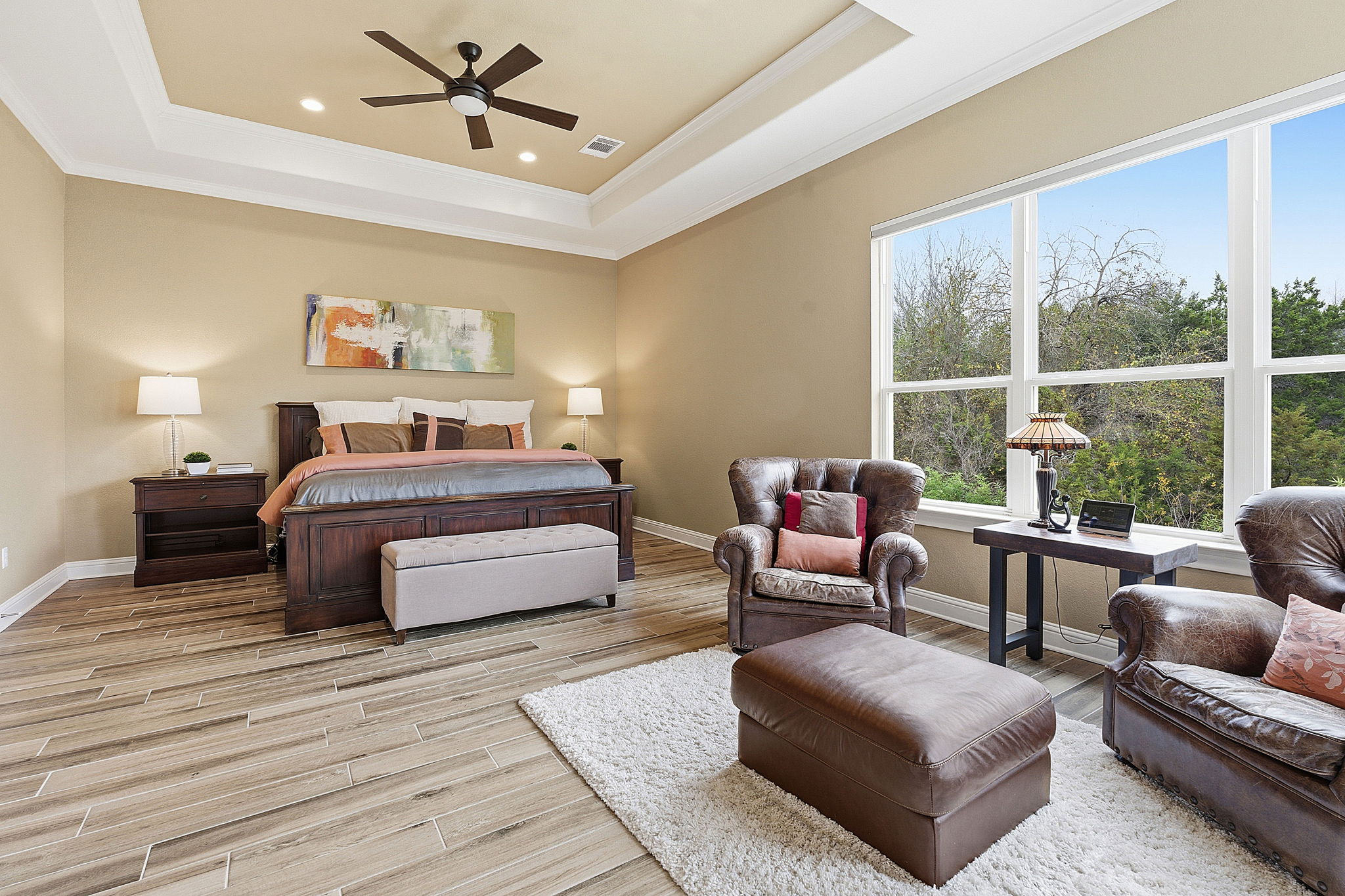 2824 Wedgescale Pass Leander, TX 78641 - Photo 19 of 40 The expansive primary retreat overlooks the greenbelt and features a tray ceiling, ceiling fan and down lights