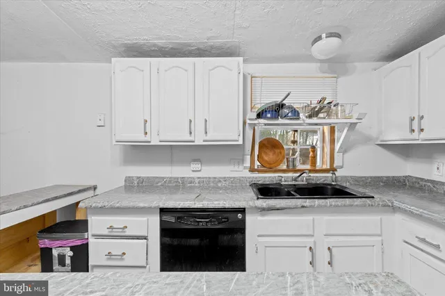a kitchen with stainless steel appliances granite countertop a stove and a microwave