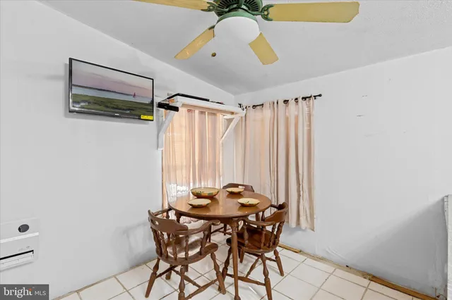 a view of a dining room with furniture and a window