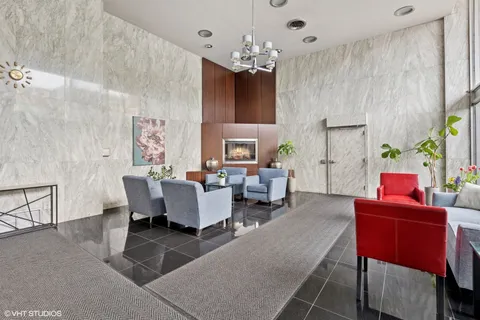 a living room with furniture a chandelier and a chandelier