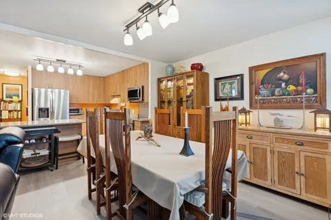 a view of a dining room with furniture and chandelier