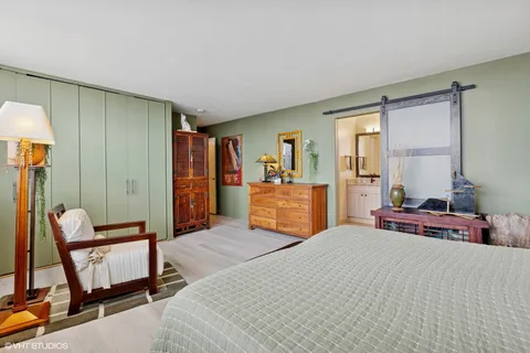 a bedroom with furniture and a window