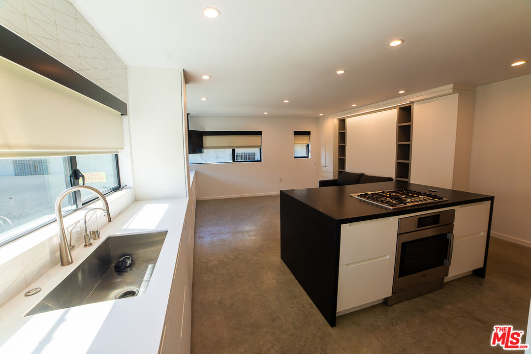 14 Brooks Avenue, Unit 8 Venice, CA 90291 - Photo 3 of 13 a kitchen with stainless steel appliances granite countertop a stove and a sink