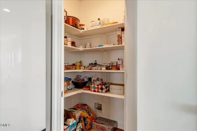 a kitchen with granite countertop kitchen island sink stove and white cabinets