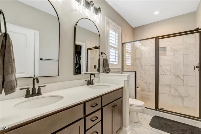 a kitchen with stainless steel appliances granite countertop a stove a sink a refrigerator a center island a table and chairs