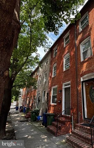 a couple of table and chairs in front of brick building