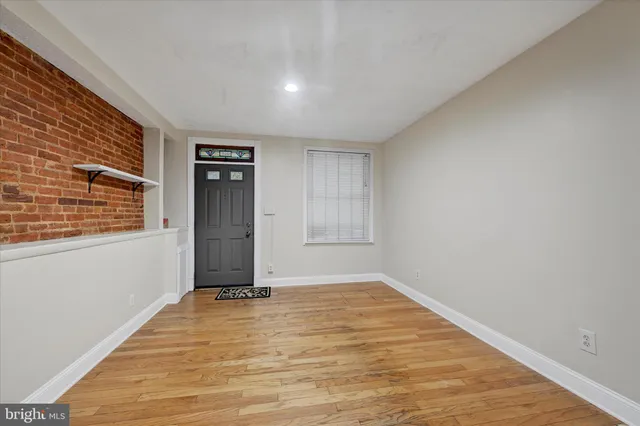 a view of a livingroom with wooden floor and a window