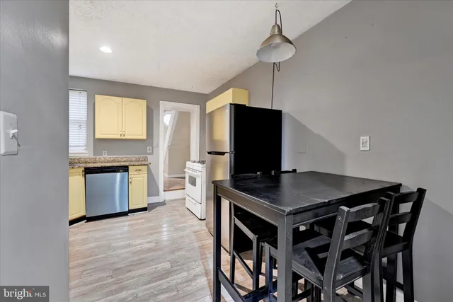 a kitchen that has a table and chairs in it