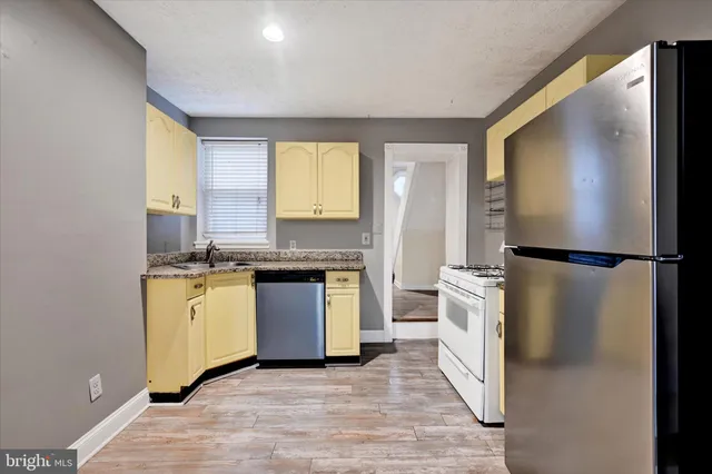 a kitchen with a refrigerator and a sink