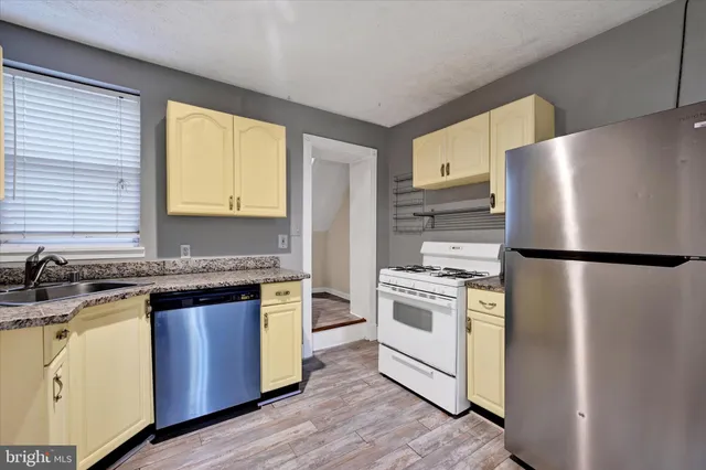 a kitchen with a refrigerator stove and sink