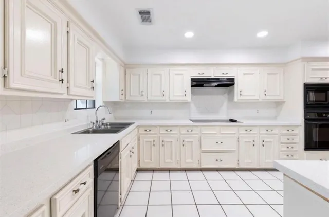 a kitchen with white cabinets and white appliances