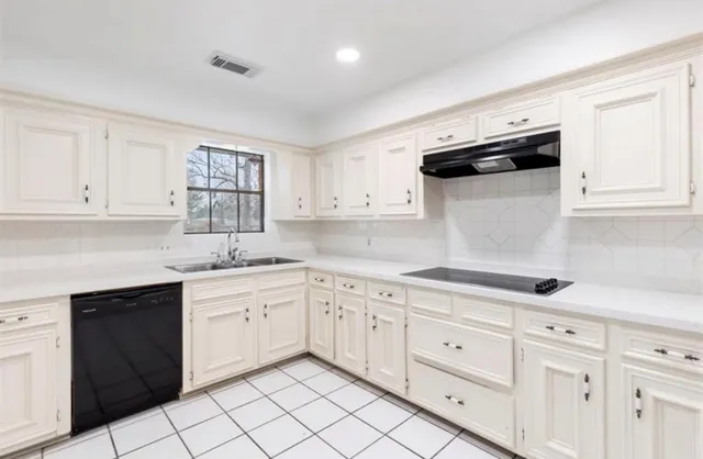 a kitchen with granite countertop white cabinets and white appliances