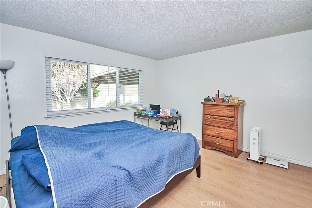 20309 East Vejar Road Walnut, CA 91789 - Photo 19 of 29 a bedroom with a bed a dresser and a large window