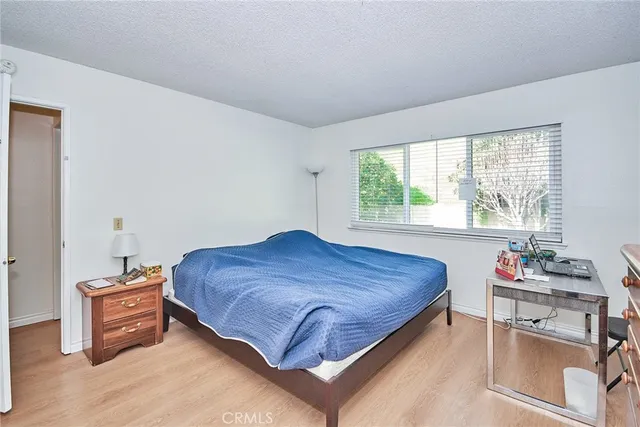 a bed sitting in a bedroom next to a window