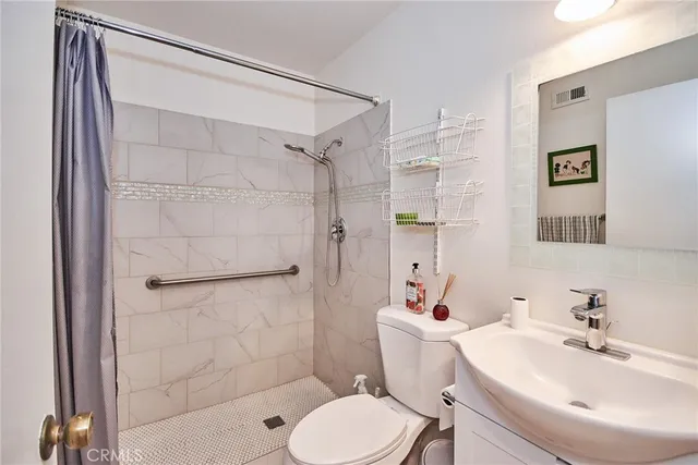 a bathroom with a sink toilet and shower