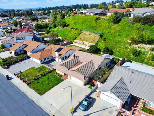 an aerial view of a house with garden space and street view