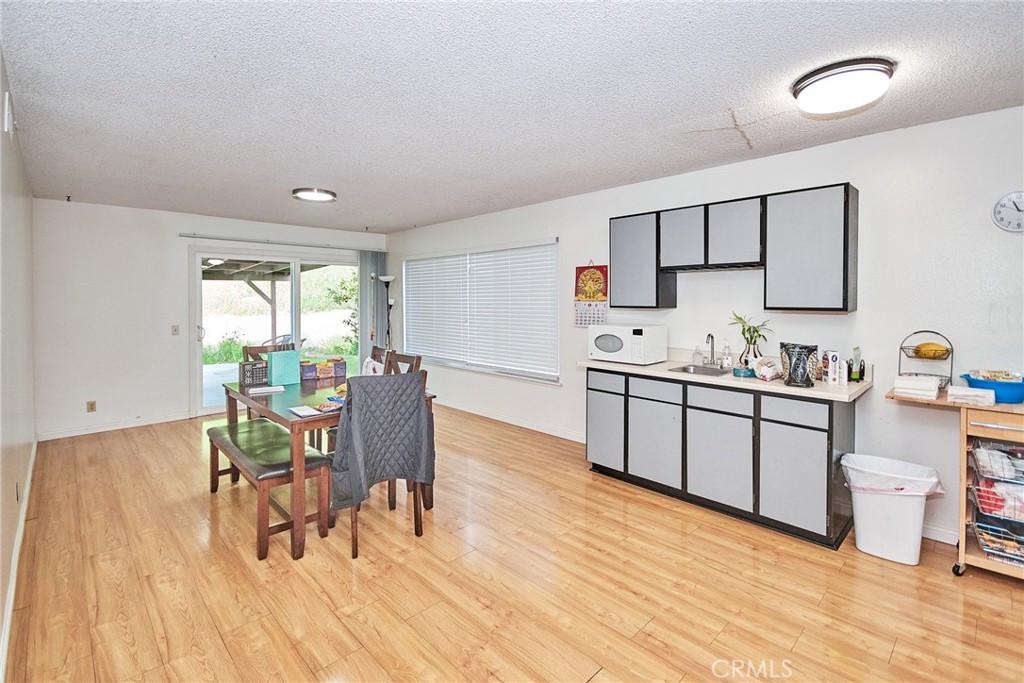 20309 East Vejar Road Walnut, CA 91789 - Photo 9 of 29 a kitchen with a table chairs a sink dishwasher window and cabinets