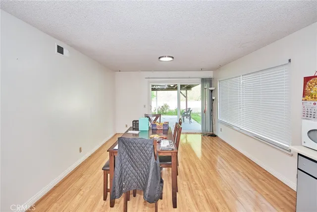 a view of a room with wooden floor and furniture