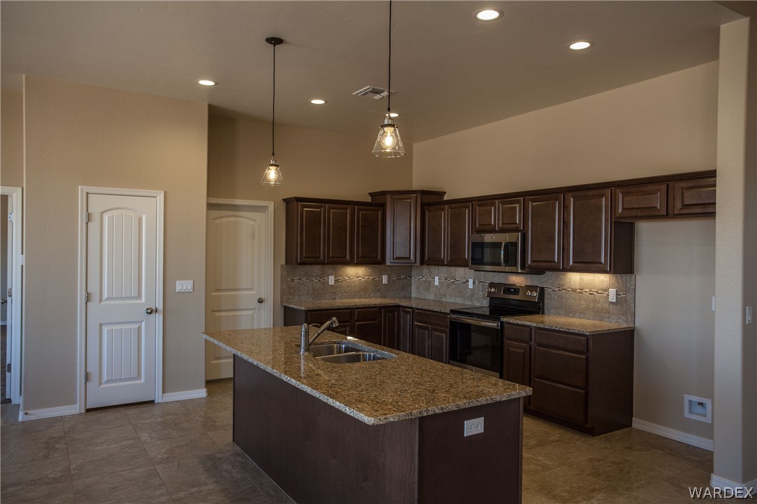 4861 North Neal Ranch Road Kingman, AZ 86401 - Photo 14 of 36 a kitchen with sink cabinets and stainless steel appliances