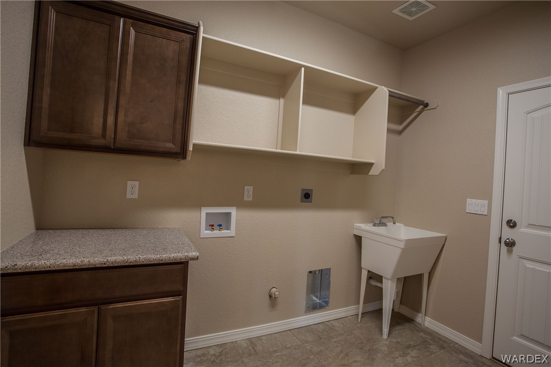 4861 North Neal Ranch Road Kingman, AZ 86401 - Photo 21 of 36 a kitchen with a sink and cabinets
